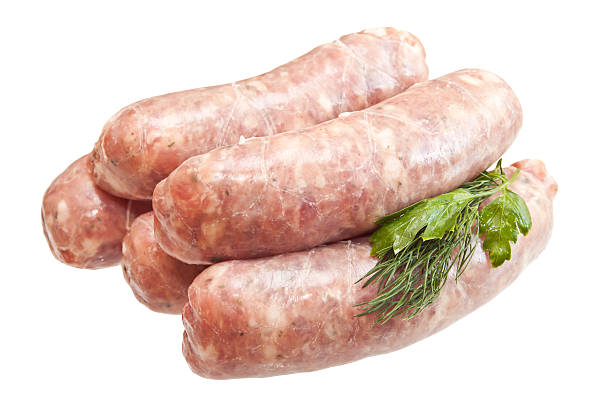 istock Raw meat sausages with greens isolated on white background 476253311
