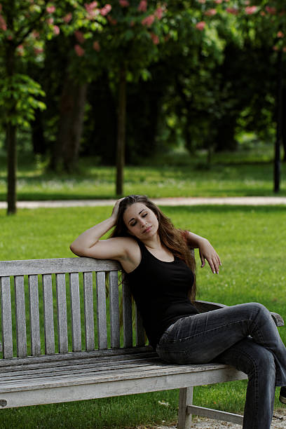 istock pretty young girl on a bench 476253799
