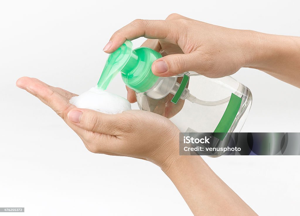 woman pressing the liquid soap woman pressing the liquid soap to her hand. 2015 Stock Photo