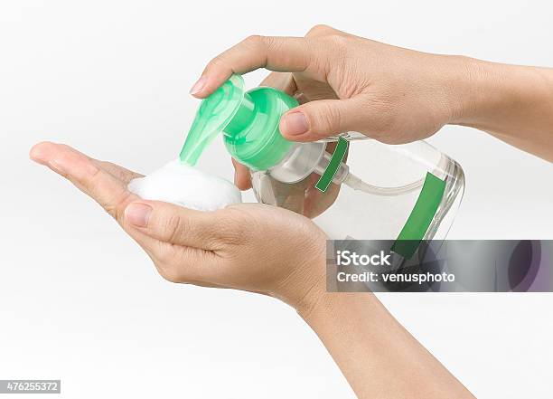 Woman Pressing The Liquid Soap Stock Photo - Download Image Now - 2015, Adult, Bottle