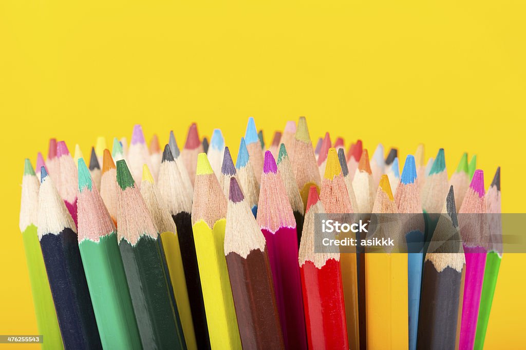 Colored Pencils colored pencils in yellow backgrounf Artist's Palette Stock Photo