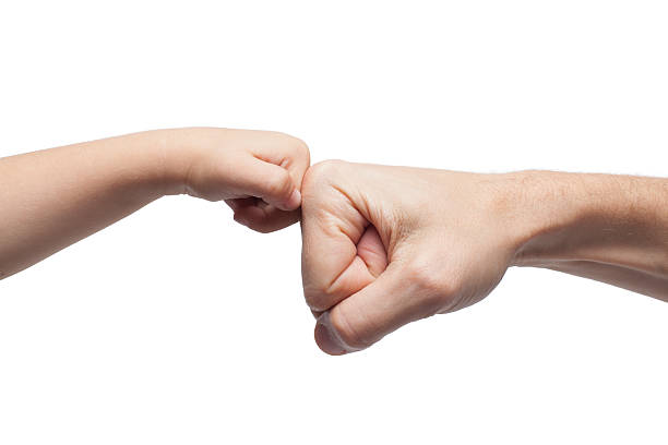 istock father and son punching fists/hands for agreement on white backg 476255556