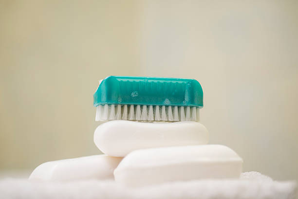Soap and brush nail cleaner on white towel