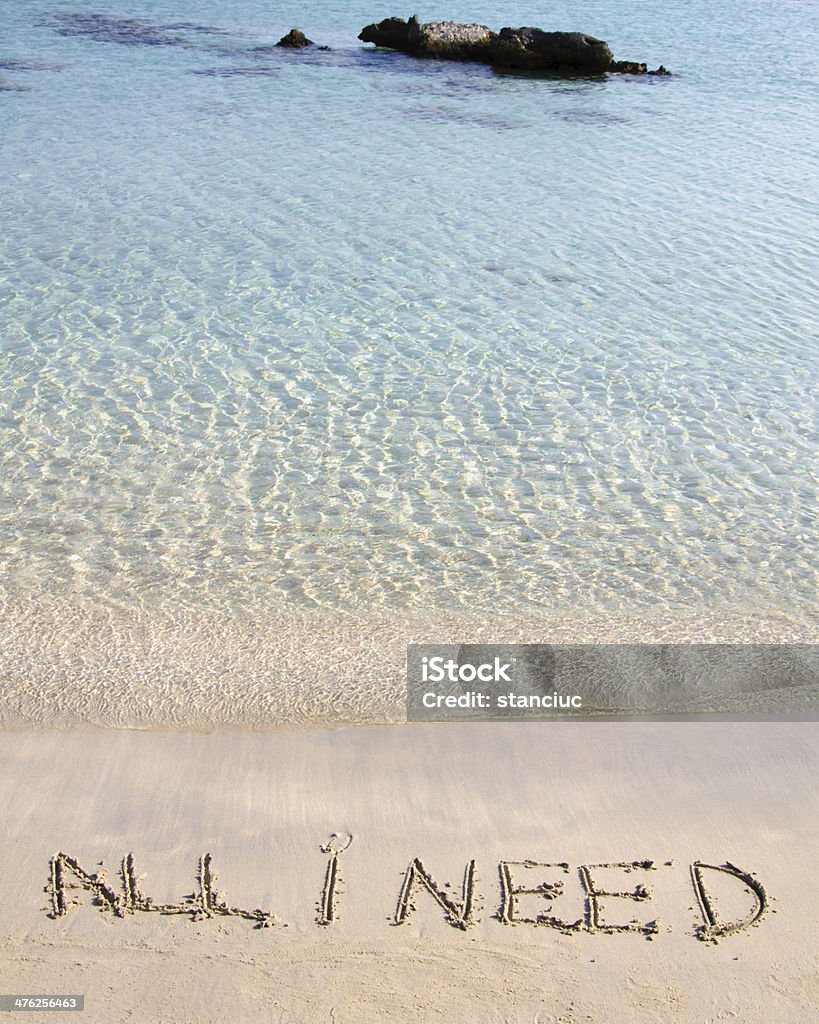 All I need message written on white sand All I need message written on white sand, with tropical sea waves in background Beach Stock Photo