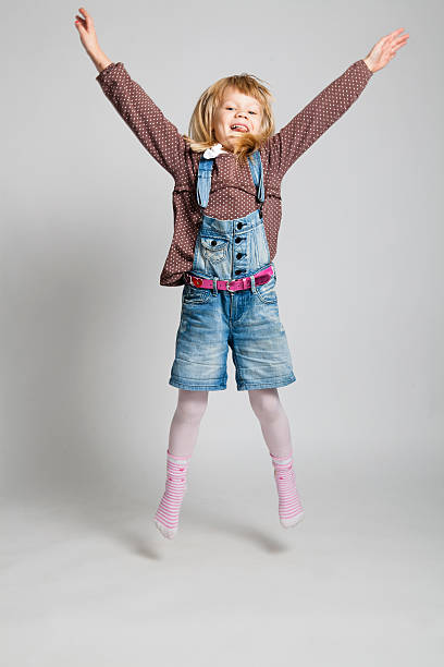istock Happy young girl jumping 476256539