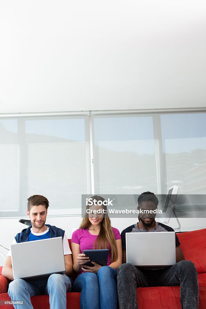 Creative team in office Creative team using technologies in office 20-24 Years Stock Photo