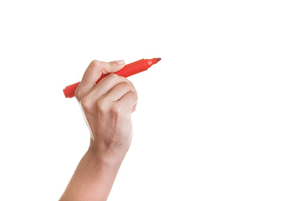 istock Red pen in a female hand for business notes. 476257357