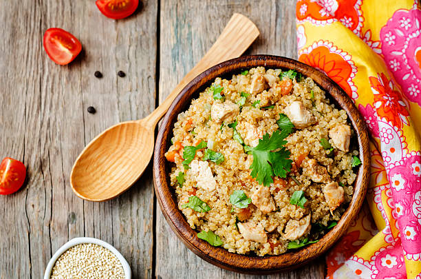 quinoa pilaf with chicken and vegetables quinoa pilaf with chicken and vegetables. the toning. selective focus pilau rice stock pictures, royalty-free photos & images