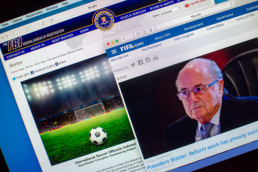 London, UK - June 4, 2015: Computer screen displaying the FIFA and FBI websites.