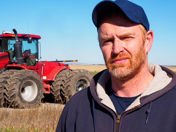 istock Farmer and Tractor in a Wheatfield 476259438