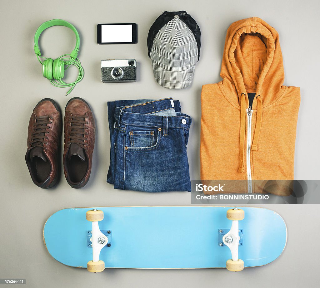 Outfit of skater man on grey background. Overhead of essentials casual boy. Sports Shoe Stock Photo