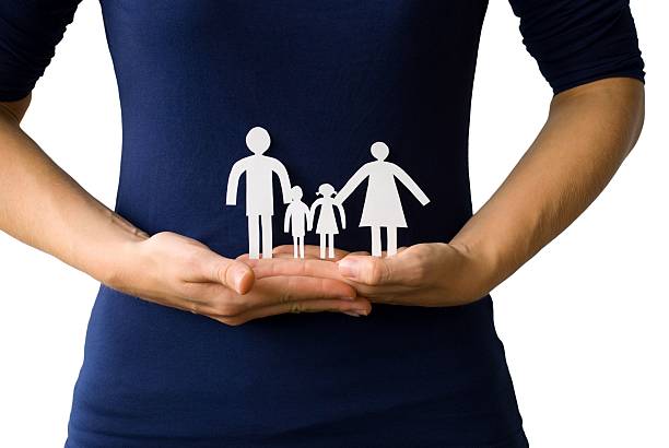 istock hands holding a paper chain family 476264611