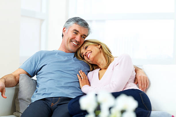 istock Romantic mature couple sitting together at home 476265517