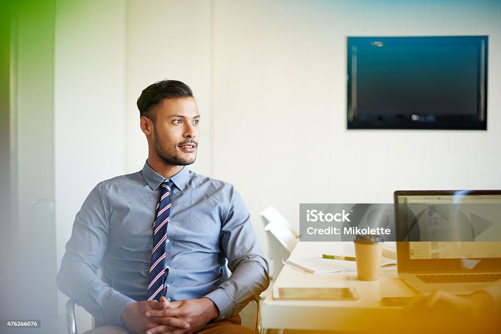 Happy with the status of his career Shot of a young businessman sitting at his desk in an officehttp://195.154.178.81/DATA/i_collage/pu/shoots/804774.jpg 2015 Stock Photo