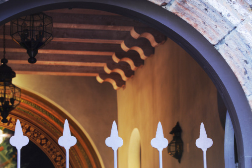 Softly illuminated mission interior viewed through its entrance arch and gate.  Yavapai County, Arizona, 2013.