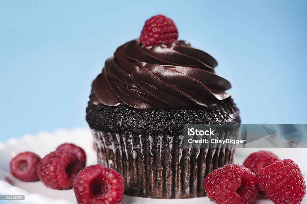 Chocolate Vegan Cupcake 2 level macro view of chocolate cupcake with raspberries Chocolate Icing Stock Photo