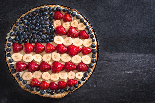 Sweet fruit and vanilla cream pie with American flag design,selective focus and blank space