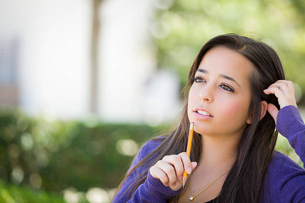 istock Pensive Mixed Race Female Student with Pencil on Campus 476270731