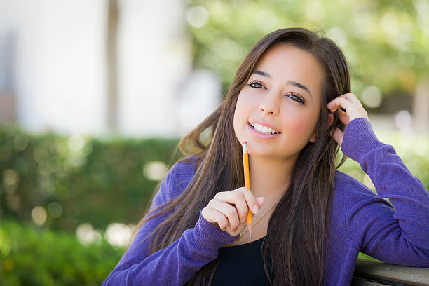 istock Pensive Mixed Race Female Student with Pencil on Campus 476270747