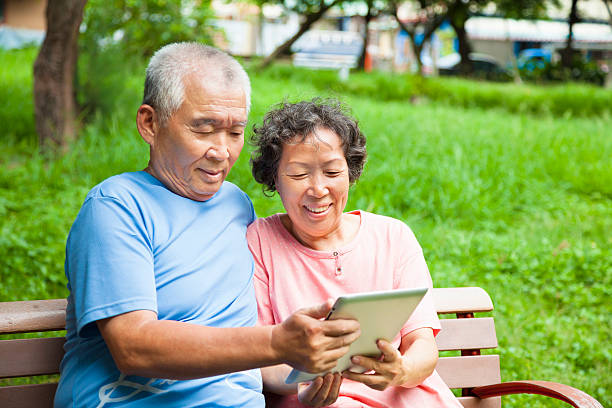 istock happy seniors couple with tablet pc in the park 476270939