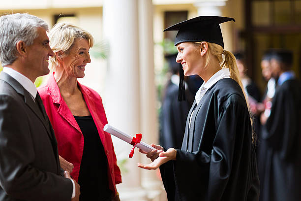 istock female graduate talking to parents 476272695