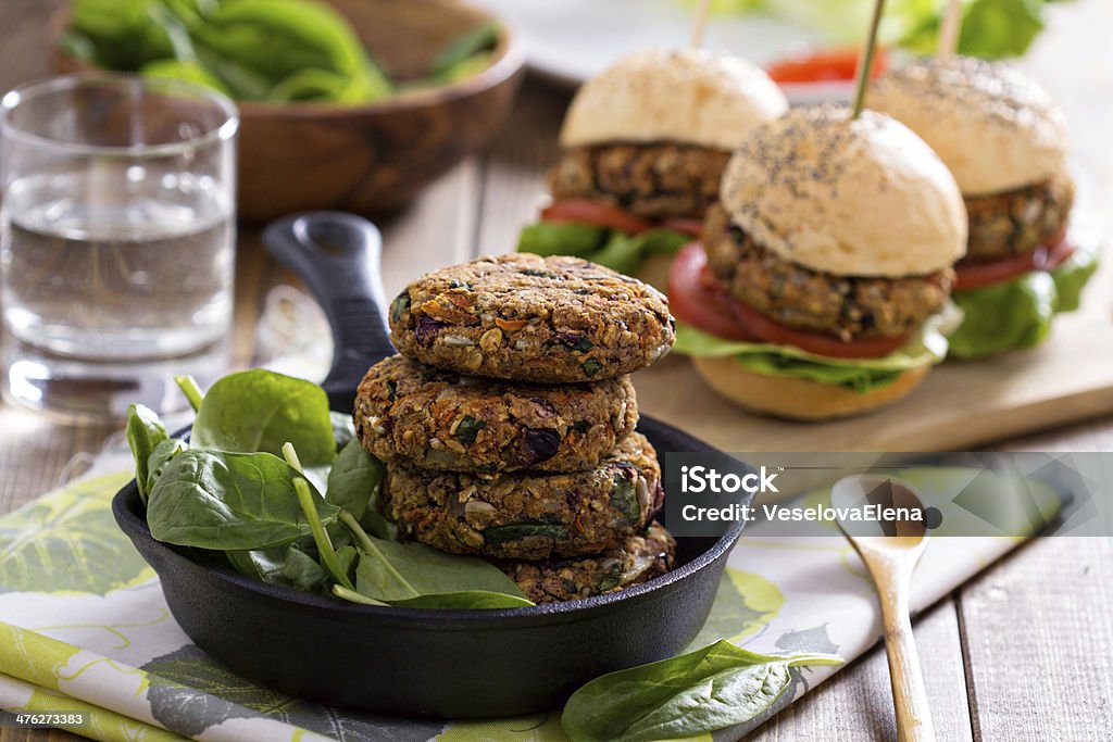 Vegan burgers with beans and vegetables Vegan burgers with  beans and vegetables served with spinach Bean Stock Photo