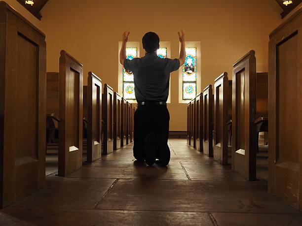 istock Man Praying In Church 476273892