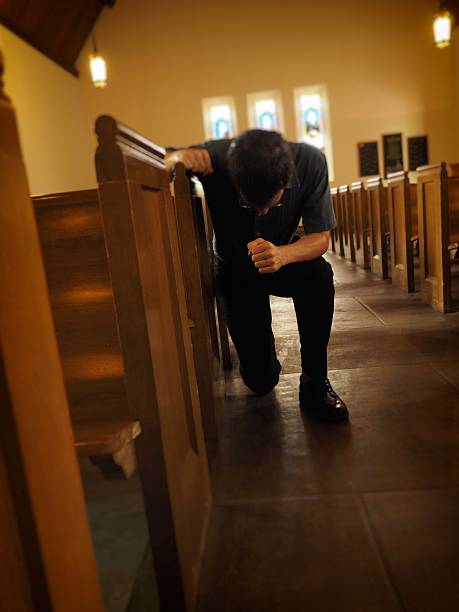 istock Man Praying In Church 476273894