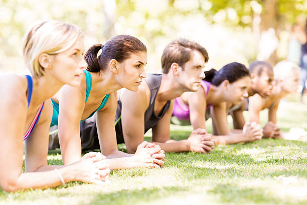 istock Determined People In Plank Position At Park 476274070