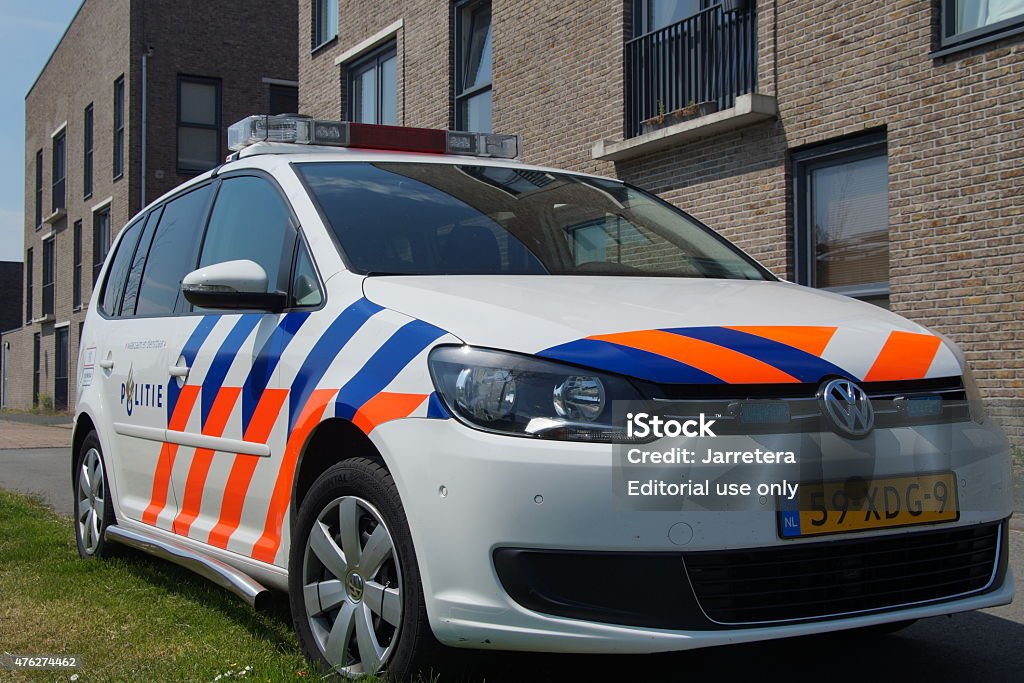 Dutch Police Car (Volkswagen Touran) - Nationale politie Almere Poort, Flevoland, The Netherlands - June 5, 2015: Dutch National Police Car , Volkswagen Touran, parked on a city street in front of a apartment building. Nobody in vehicle. Netherlands Stock Photo