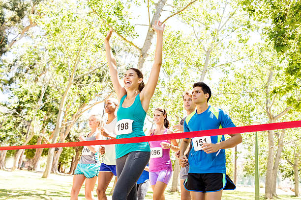 istock Female Marathon Runner Crossing Finish Line 476278492