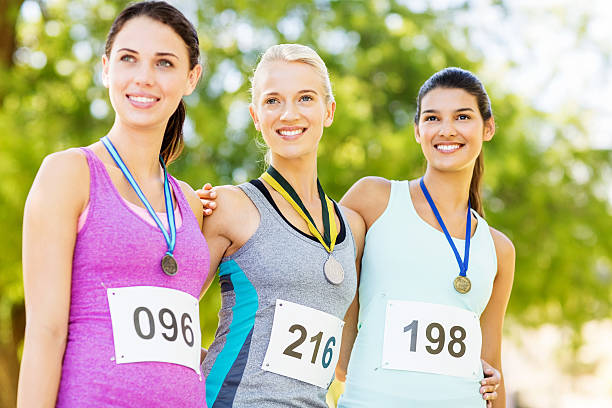 istock Attractive Marathon Runners With Medals Looking Away 476279454