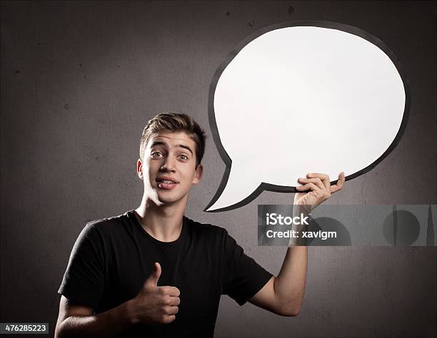 Young Man Holding A Speech Bubble Stock Photo - Download Image Now - Abstract, Adult, Bubble