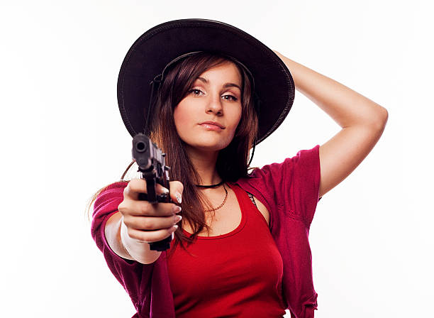 istock Young cowgirl holding gun 476285684