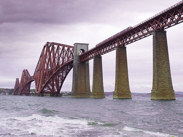 istock train crossing the forth bridge in scotland 476286542