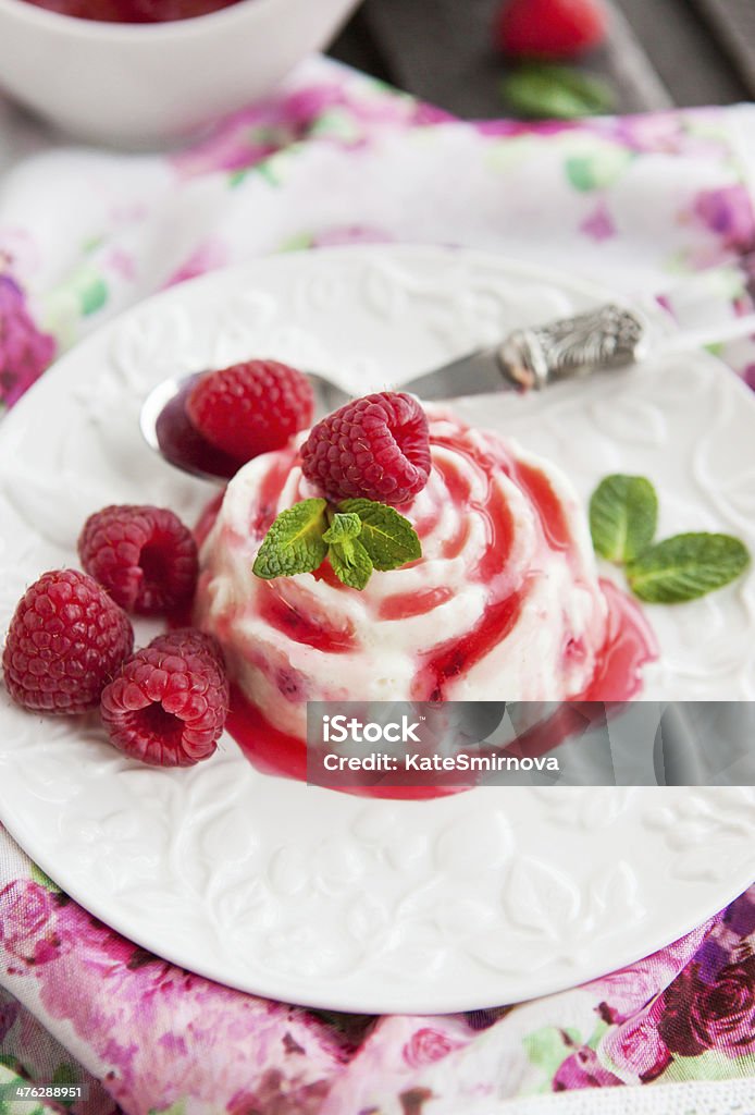 Delicious dessert with raspberry sauce and fresh berries Delicious dessert (panna cotta) with raspberry sauce decorated with fresh berries and mint Berry Fruit Stock Photo