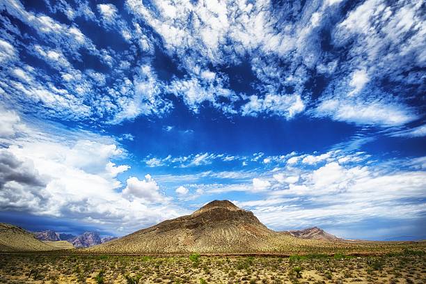 istock Lonely Mountain circled by clouds in the Desert 476290059