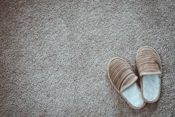 Slippers on the mat, top view with space for text
