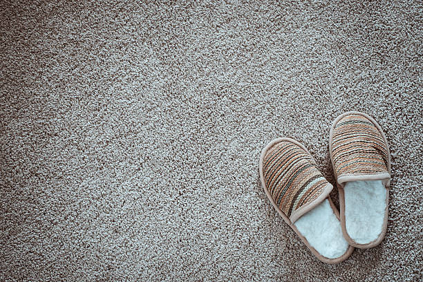Slippers on the mat, top view with space for text stock photo