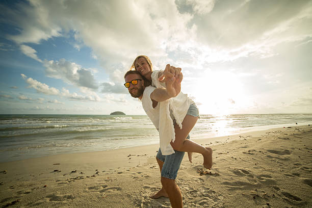 istock Playful couple on the beach at sunset 476291224