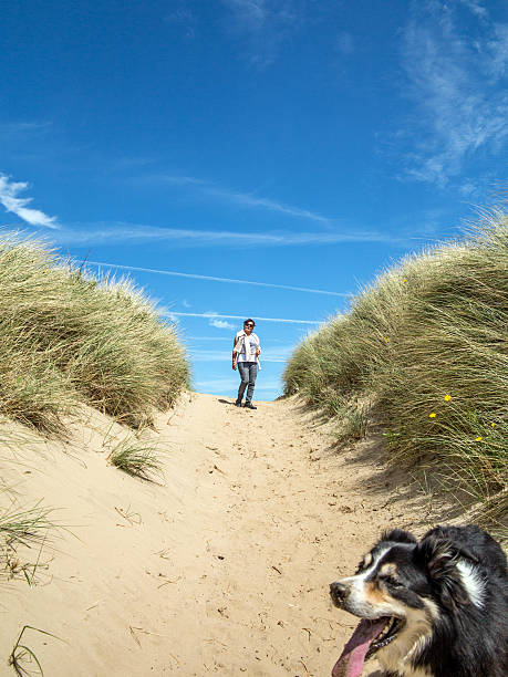 istock Mature hispanic woman walking on beach dunes with blue sky 476291254