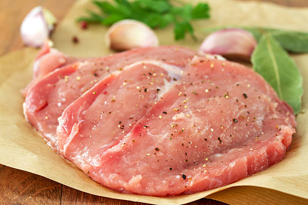 istock pork with garlic and parsley on paper 476291400