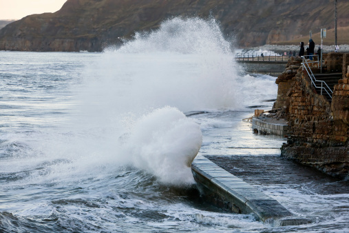 Large waves crash against the sea wall in Scarborough in north east England, on February 16, 2014. High tides and strong winds caused flooding in parts of England on Friday as severe flood warnings remained in place.