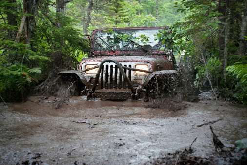 Mount Uniacke, Nova Scotia, Canada - July 4, 2009:  A Jeep 4x4 maneuvers through a deep mud bog.