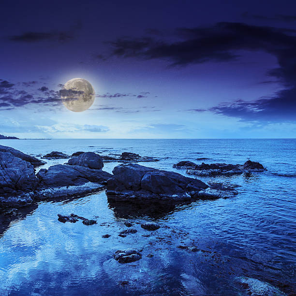 istock sea wave breaks about  boulders at night 476294603