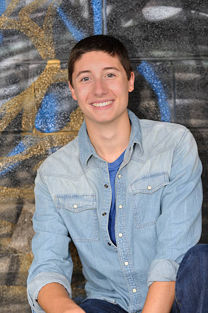 istock Teenage Boy Smiling with Grafitti Background 476295779