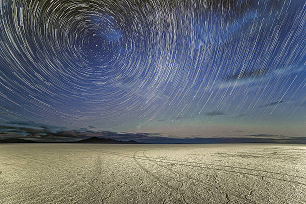 Star Trails over the Bonneville Salt Flats The planet Saturn and a multitude of stars seemingly rotate around Polaris, the North Star, in this composite photo over the Bonneville Salt Flats. tooele stock pictures, royalty-free photos & images