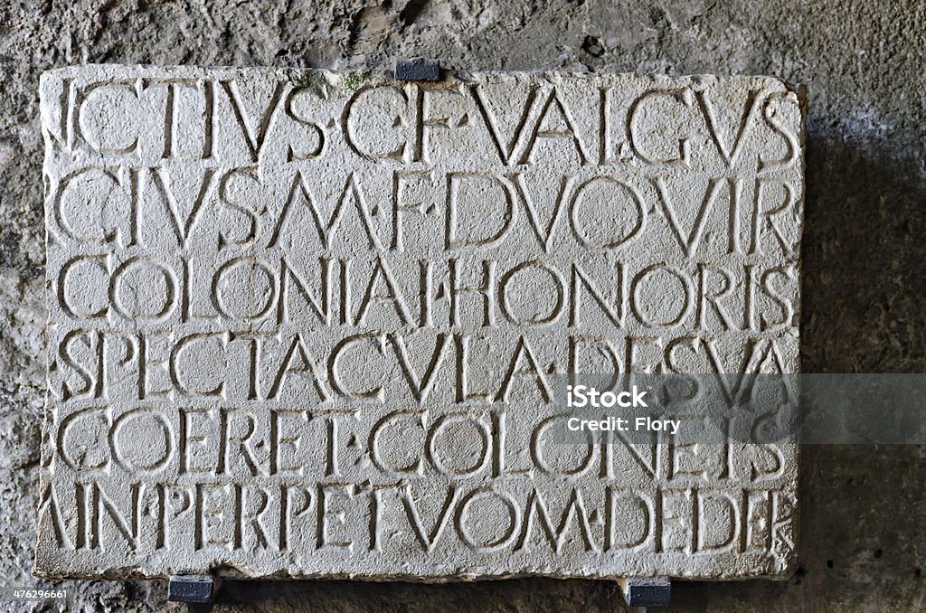 Roman inscription in 'Amphitheatre at Pompeii marble plaque at the entrance of Roman amphitheater in Pompeii, where the Gladiators fought Stone - Object Stock Photo