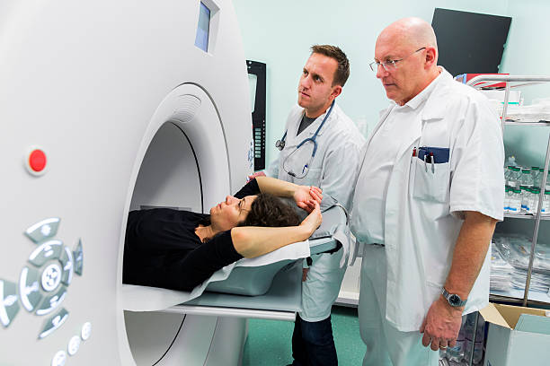 istock Chief radiologist,young doctors and  patient,having PET scan 476299391