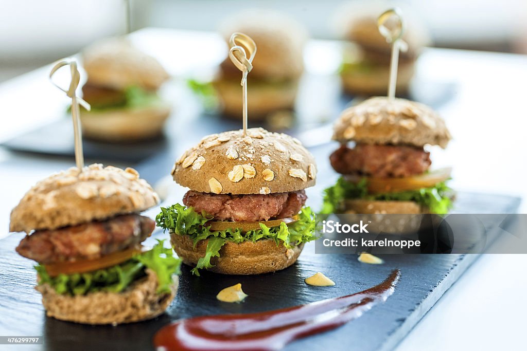 Multiple min beef hamburgers. Close up of mini hamburgers at catering event. Small Stock Photo
